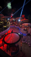 Monaco nighttime venue with illuminated circular platforms observed