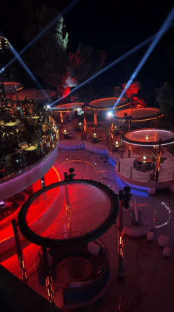 Monaco nighttime venue with illuminated circular platforms observed