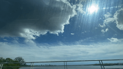 Vehicle crosses Ottawa bridge under bright sunny skies