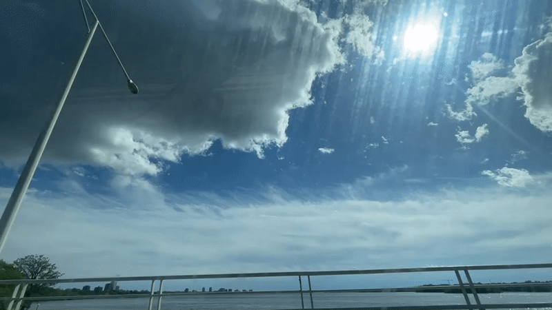 Vehicle crosses Ottawa bridge under bright sunny skies