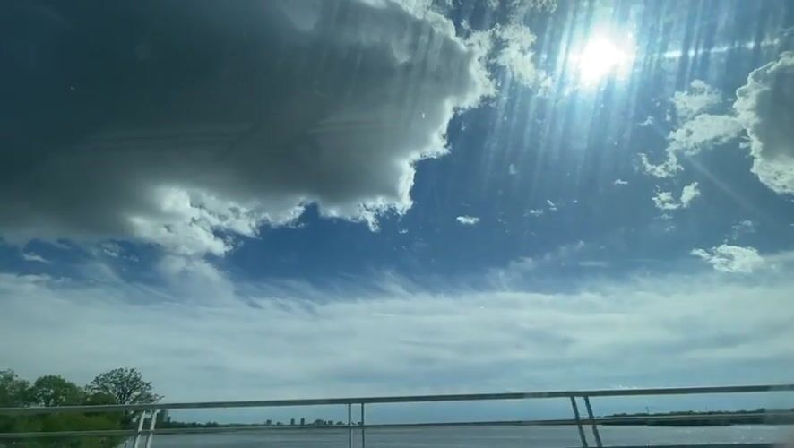 Vehicle crosses Ottawa bridge under bright sunny skies