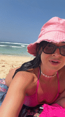 Woman documents beach day in pink bikini across Bali locations