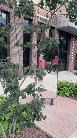Pink outfit, city plazas, murals, and construction across an urban afternoon