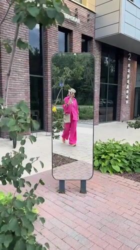 Pink outfit, city plazas, murals, and construction across an urban afternoon
