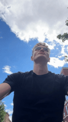 Young man gazes skyward in London afternoon