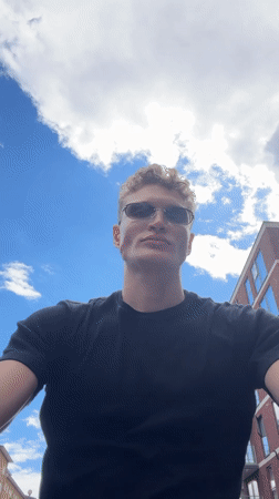 Young man gazes skyward in London afternoon
