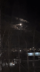 Full moon observed through clouds in Chaikovsky, Russia