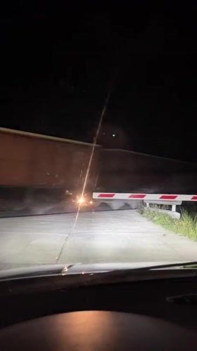 Train crosses road at night in Anevo, Bulgaria
