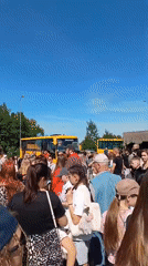 Morning crowd boards buses in Sudogda with police presence