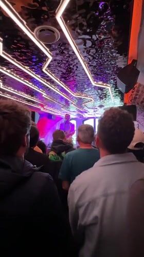 Saxophonist performs at Brighton venue under purple lights
