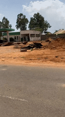Road scenes documented in Nigeria show damaged gas station, cattle