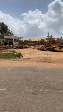 Road scenes documented in Nigeria show damaged gas station, cattle