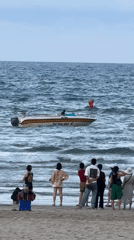 Parasailing, volleyball, and speedboats at a busy Đà Nẵng beach
