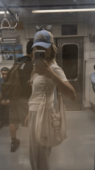 Commuter Takes Selfie in Seoul Subway Car Mirror