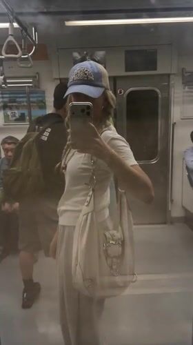 Commuter Takes Selfie in Seoul Subway Car Mirror