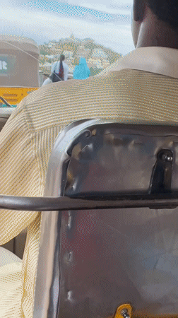 Auto-rickshaw ride through busy Rafin Par streets, Nigeria