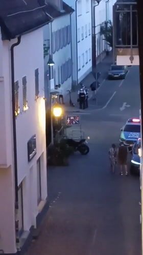 Police stop on a Winnenden cobblestone street, evening