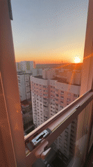 Sunset observed over Khimki apartment buildings from window