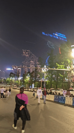 Nighttime crowds gather across central Chongqing public spaces