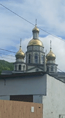 Orthodox church with golden domes filmed in Olginka, Russia