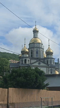 Orthodox church with golden domes filmed in Olginka, Russia