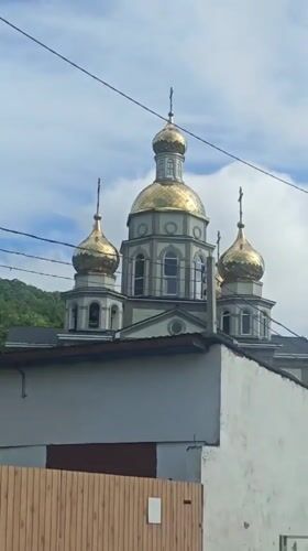 Orthodox church with golden domes filmed in Olginka, Russia