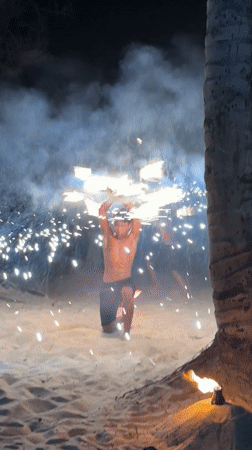 Fire performers stage nighttime beach show in Kamala Thailand