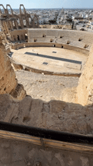 Tourist explores ancient Roman amphitheater ruins in Tunisia