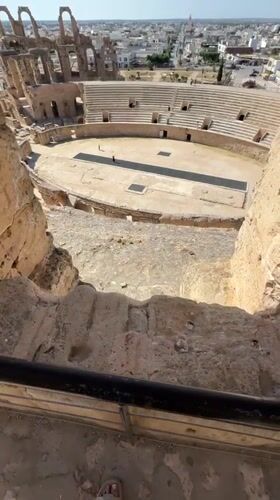 Tourist explores ancient Roman amphitheater ruins in Tunisia