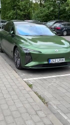 Green electric car and cyclist spotted in Tallinn