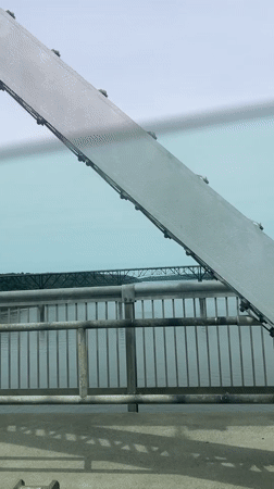 Vehicle crosses bridge in Poughkeepsie, structural view captured
