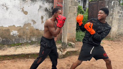 Informal boxing sparring session on dirt ground in Ihiagwa