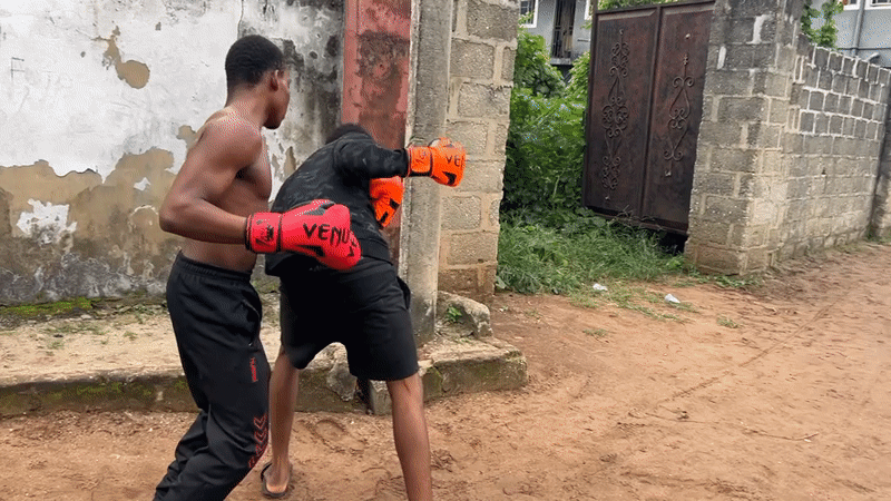 Informal boxing sparring session on dirt ground in Ihiagwa