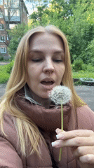 Woman poses with spring flowers in Rusanovo photo session