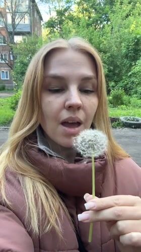 Woman poses with spring flowers in Rusanovo photo session