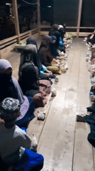 Women gather indoors in organized seating in Lhokjok, Indonesia
