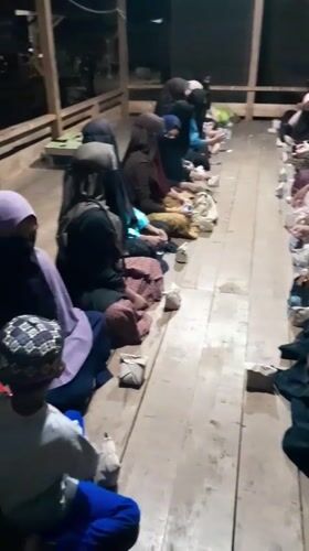 Women gather indoors in organized seating in Lhokjok, Indonesia