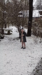 Woman photographed in snowy Kratovo garden during April snowfall
