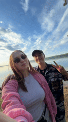 Young couple takes selfie by lake in Chaikovsky, Russia