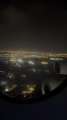 Traveler captures nighttime aerial views of illuminated Dubai cityscape