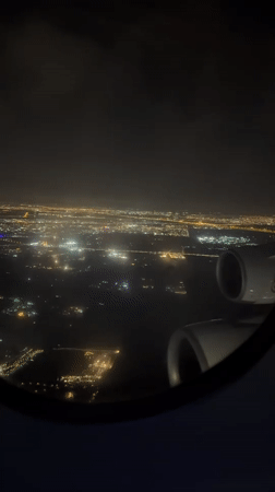 Traveler captures nighttime aerial views of illuminated Dubai cityscape