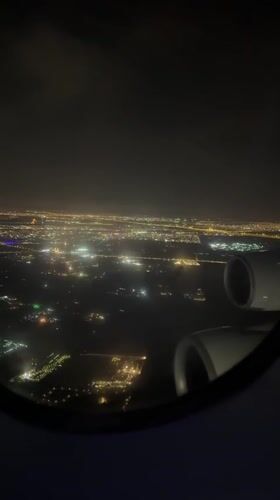 Traveler captures nighttime aerial views of illuminated Dubai cityscape