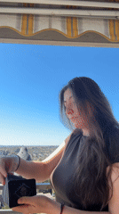 Woman draws tarot cards on sunny balcony in Waiblingen