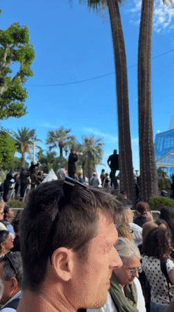 Crowd gathers outside modern building in Cannes