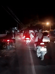 Nighttime motorcycle traffic captured in Keudebayu, Indonesia