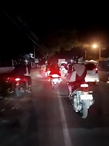 Nighttime motorcycle traffic captured in Keudebayu, Indonesia