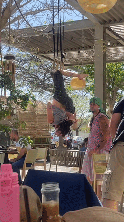 Gymnast performs on rings at busy Mitzpe Ramon cafe