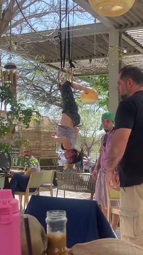Gymnast performs on rings at busy Mitzpe Ramon cafe