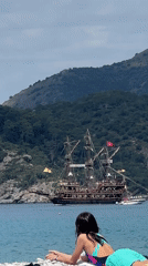 Child watches Turkish pirate ship from Fethiye beach