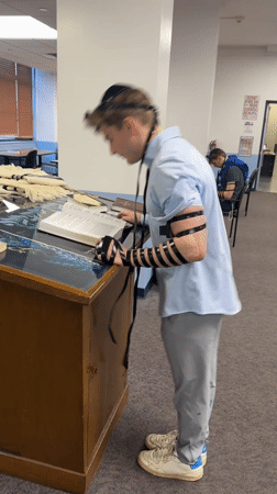 Young man conducts morning prayers at NYC synagogue